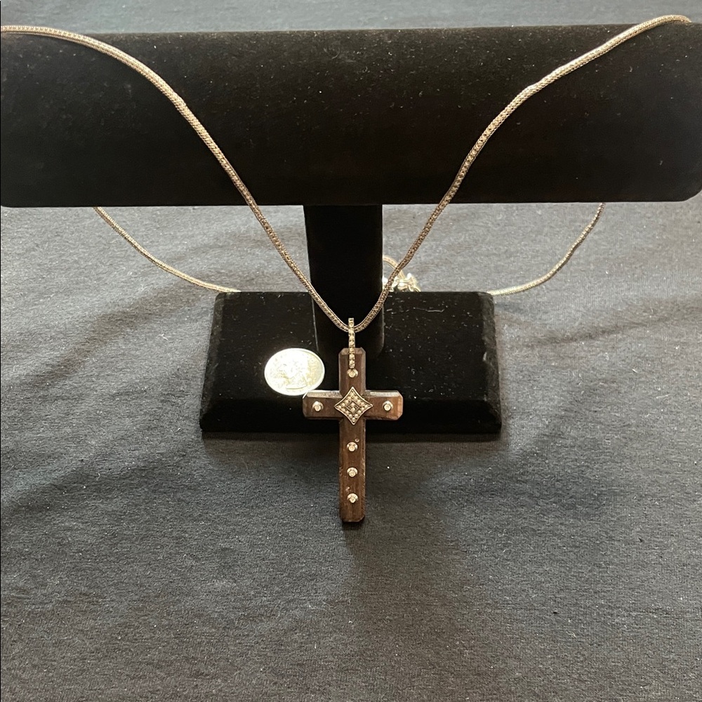 Elegant Silver Cross Pendant Necklace on Wood